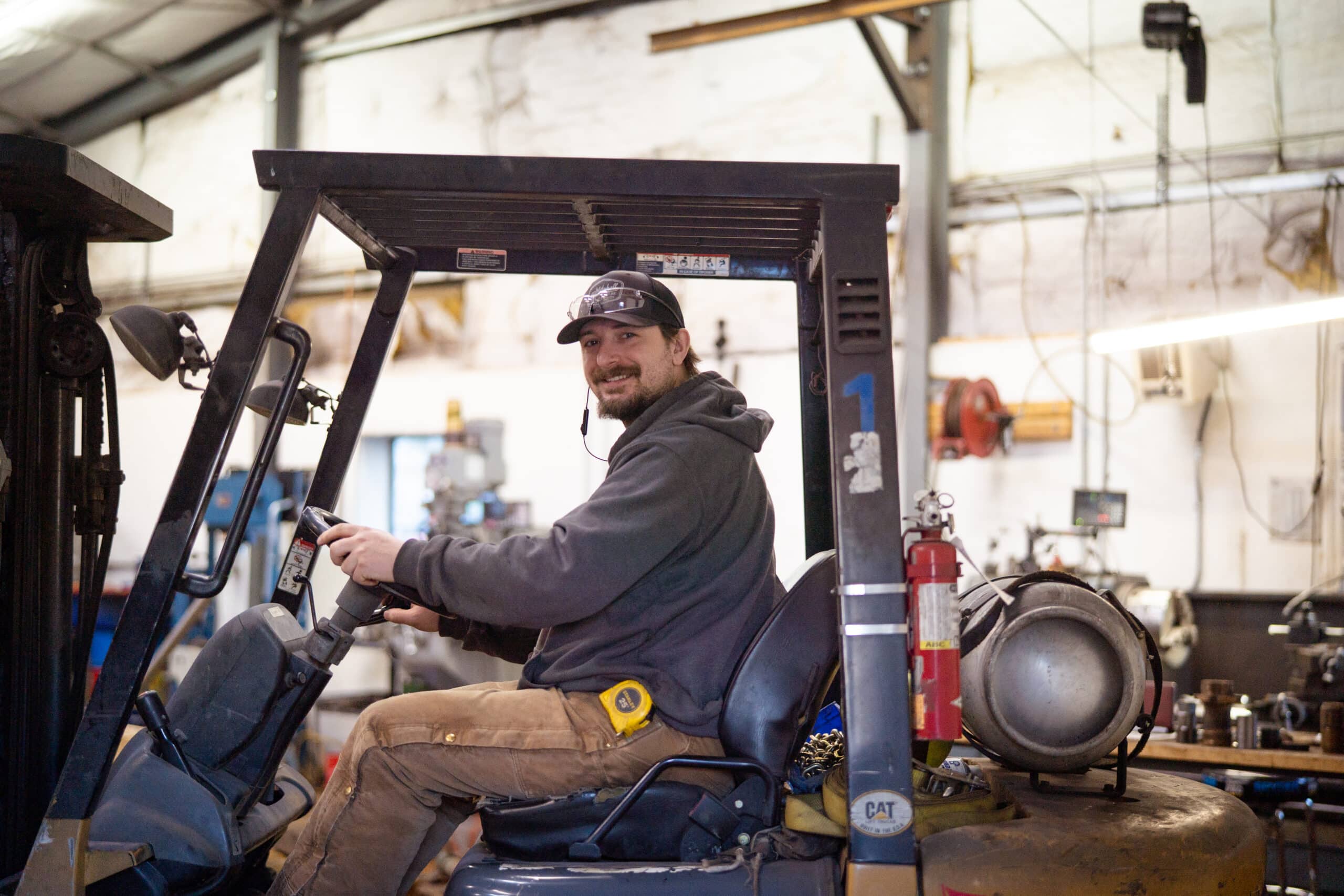 A man driving a forklift