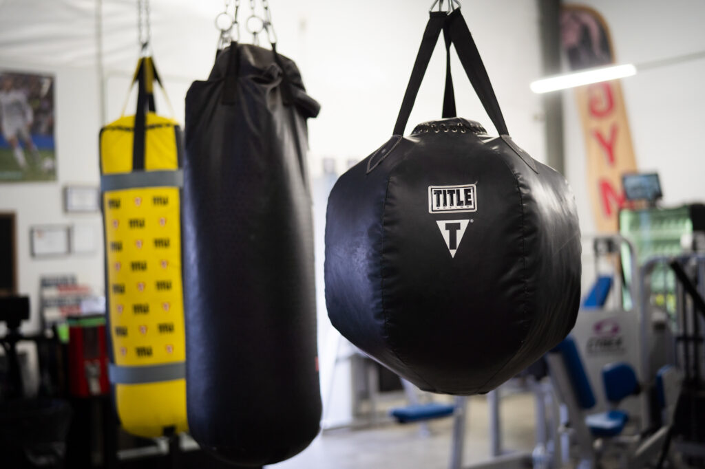 A black rounded punching bag that reads "Title"