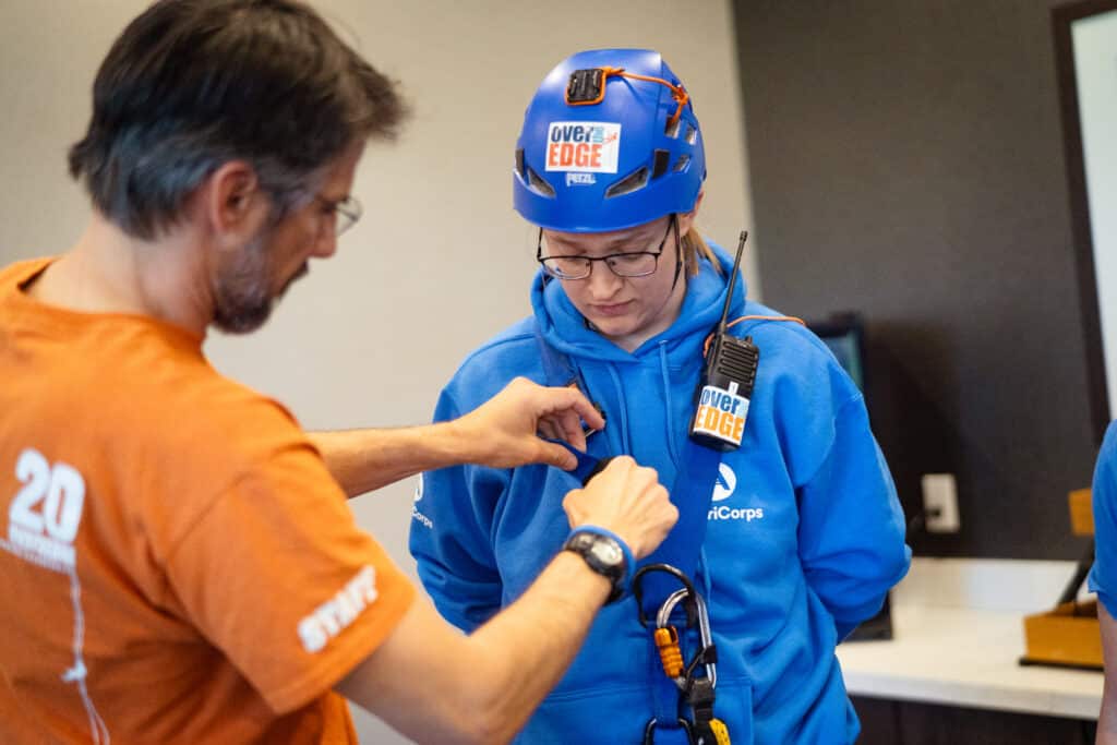 A woman getting her gear ready to rappel off the Residence Inn Building