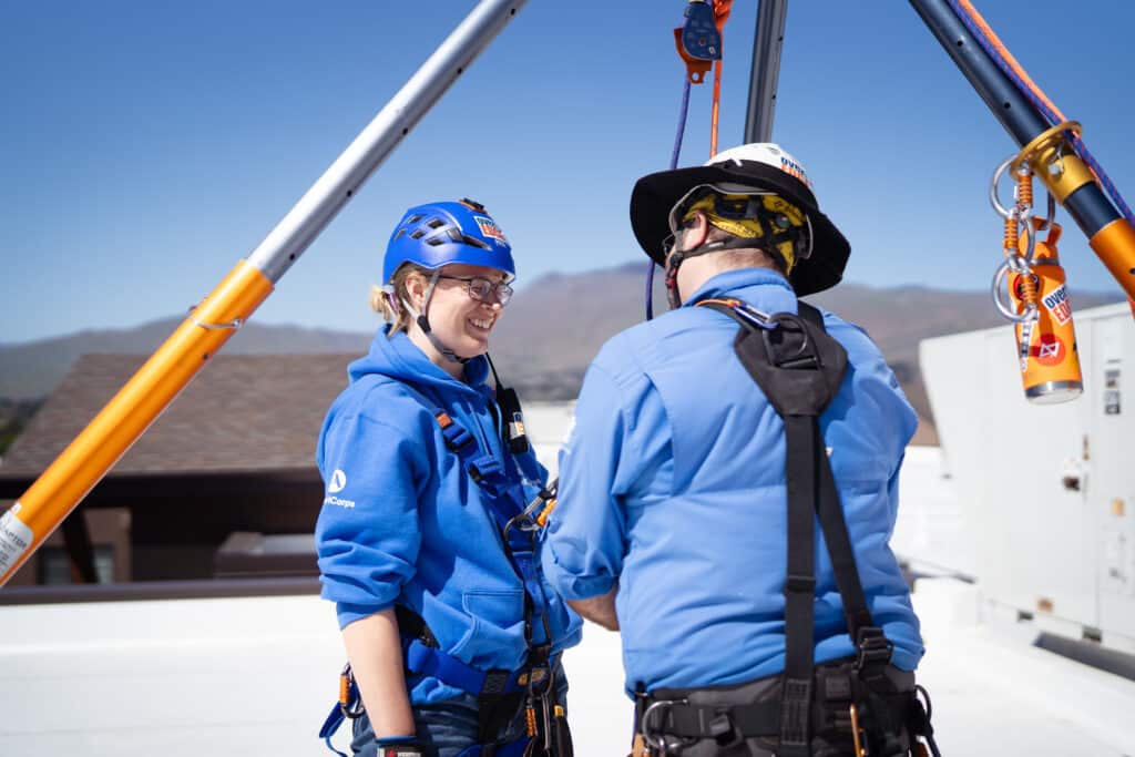 Woman getting her gear on in preparation to rappel off the Residence Inn building