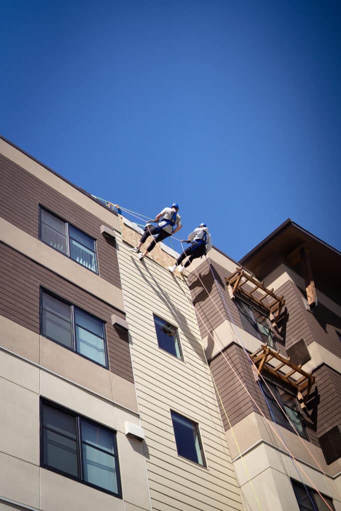Two individuals rappelling off the Residence Inn Building