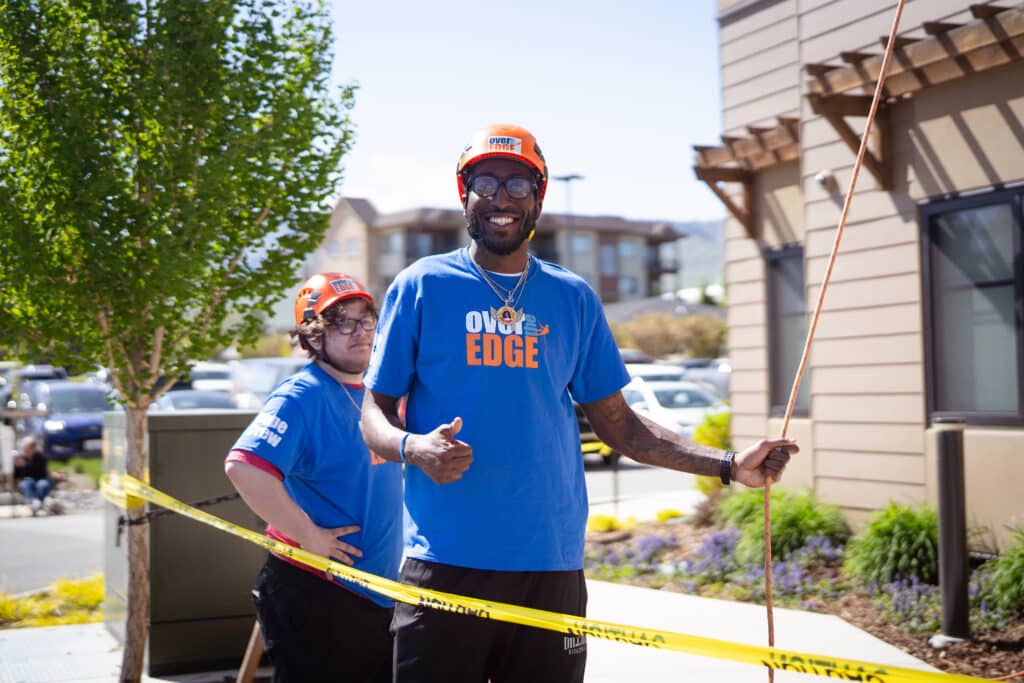 Two Over the Edge members smiling at the camera