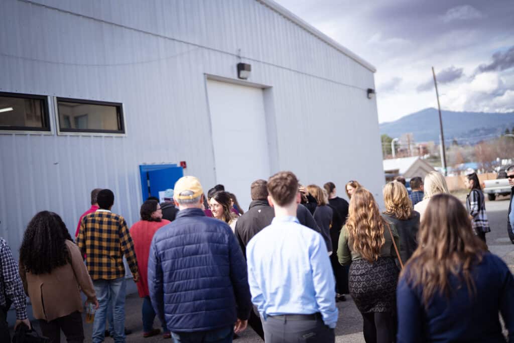 A large group of adults gathered together at CDCAC'S Food Pantry