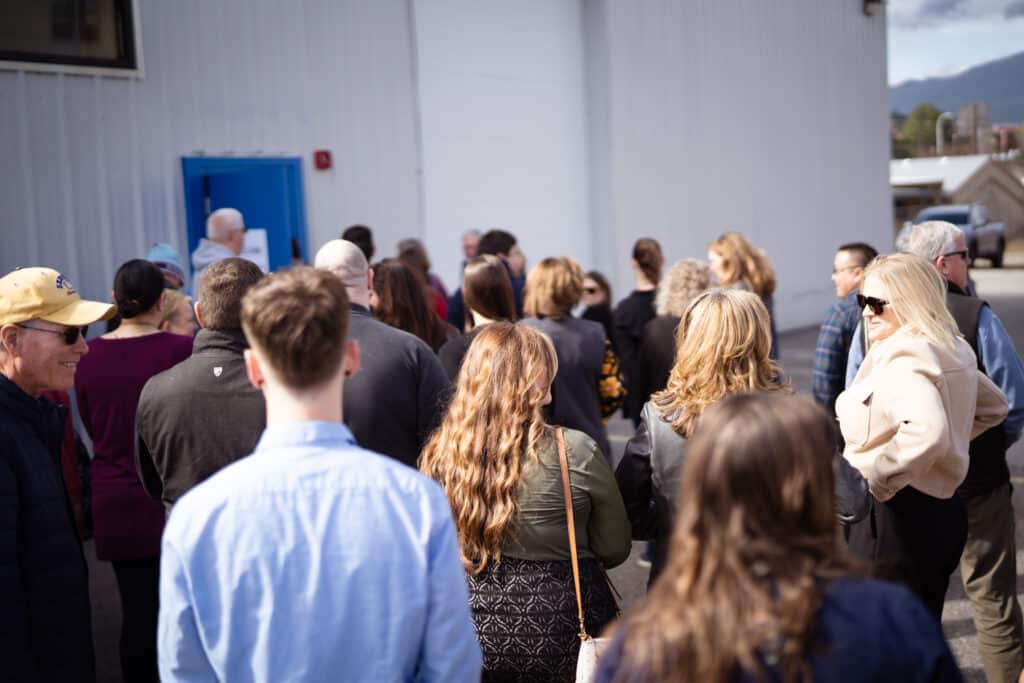 A large group of adults gathered together at CDCAC'S Food Pantry
