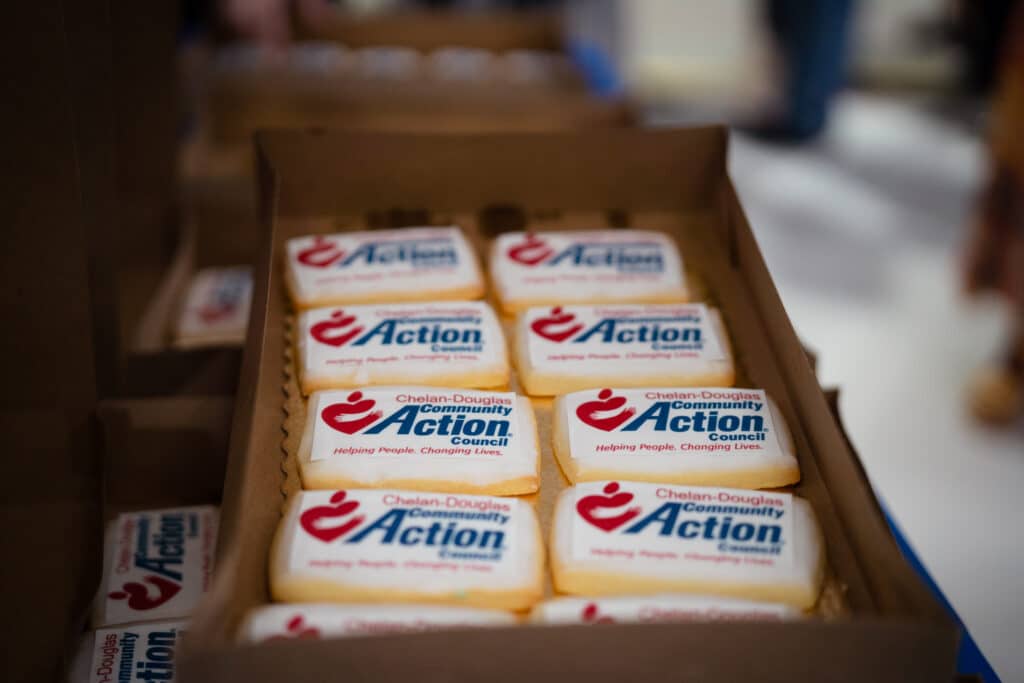 Sugar cookies inside a box with CDCAC'S Logo on the top of the cookies