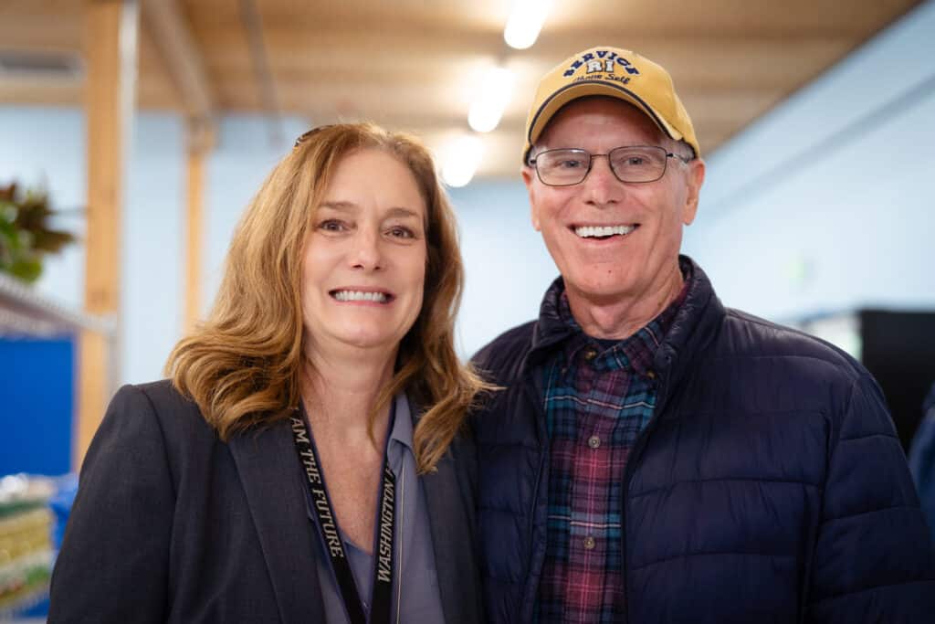 Two adults smiling at the camera at CDCAC's Food Pantry Event