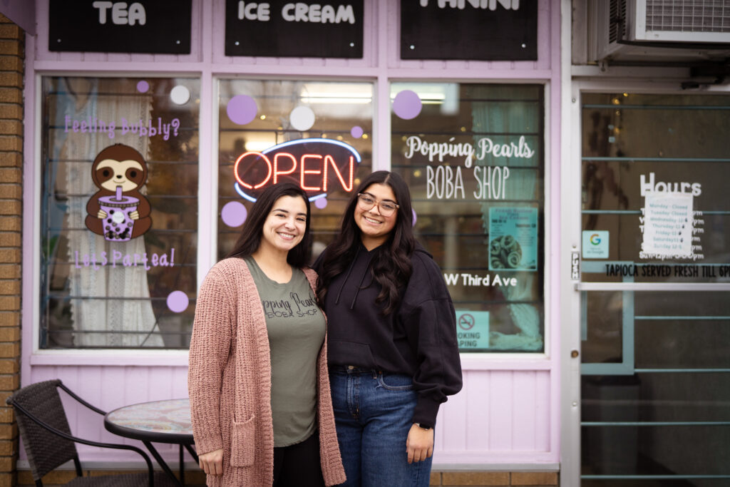 Popping Pearls Boba-10 Two women with brunette hair standing Infront of their business Popping Pearls Boba Shop