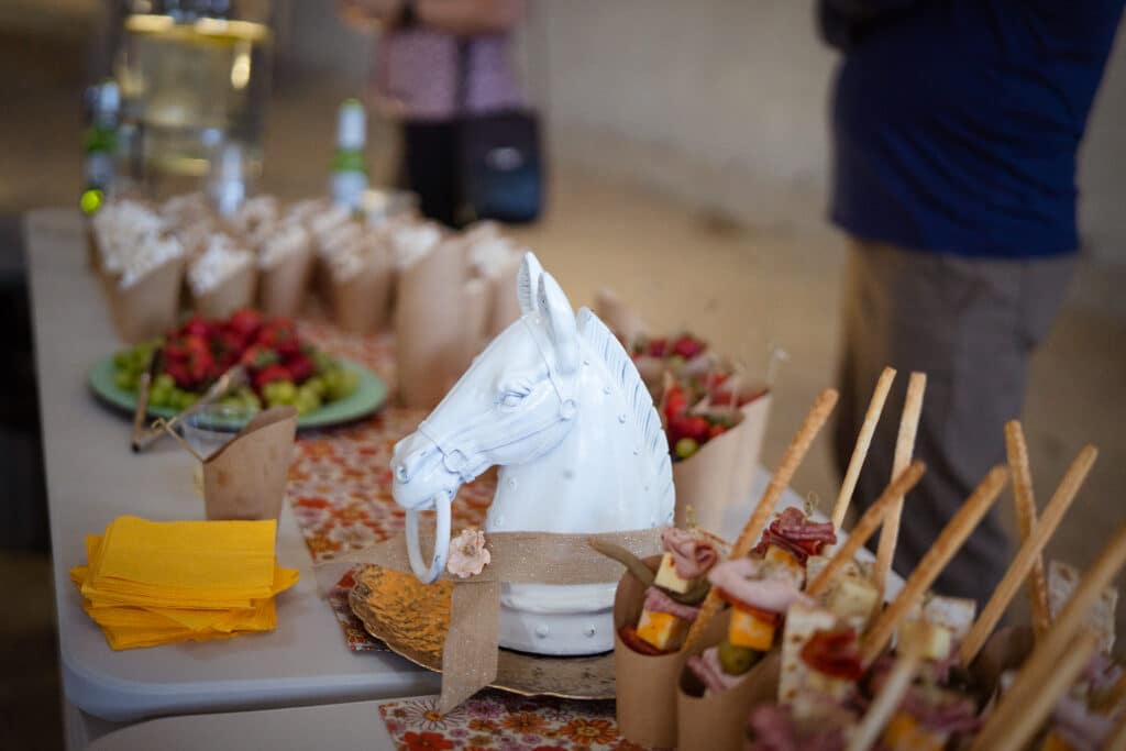 A table with horse decor and charcuterie cups