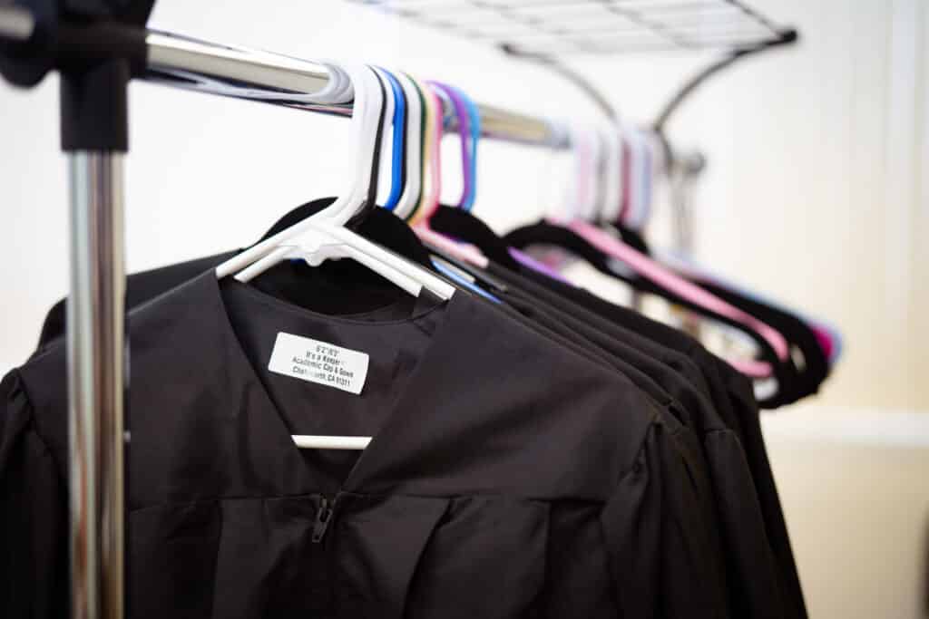 CD Graduation 2024-006 Graduation gowns hung on a rack