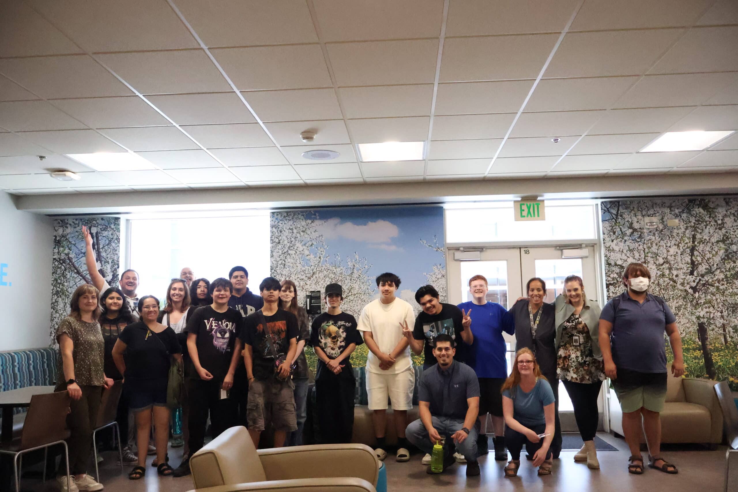 A diverse group of students and SkillSource staff gather for a photo on a worksite tour.